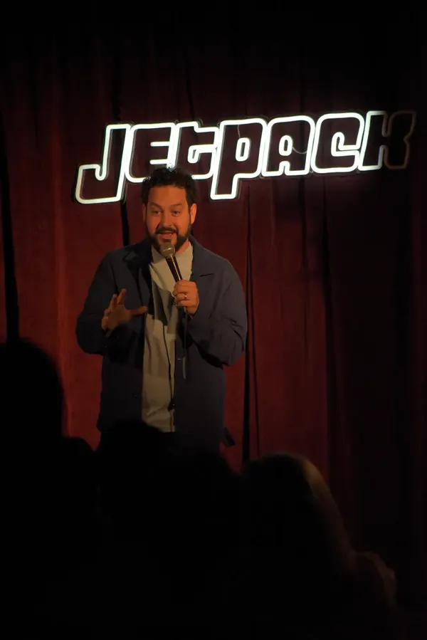 A comedian on the Jetpack stage